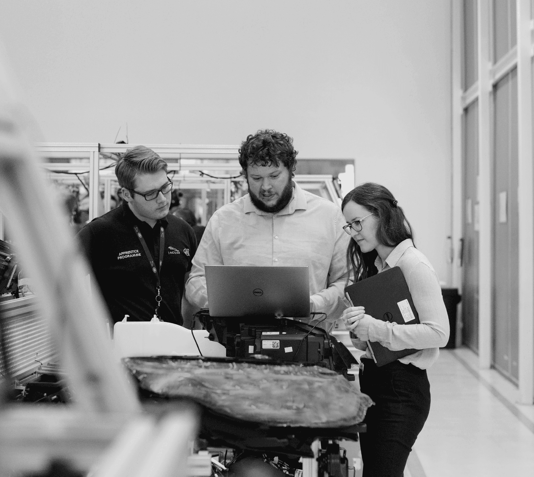 Resourcly team at a workbench on a factory floor